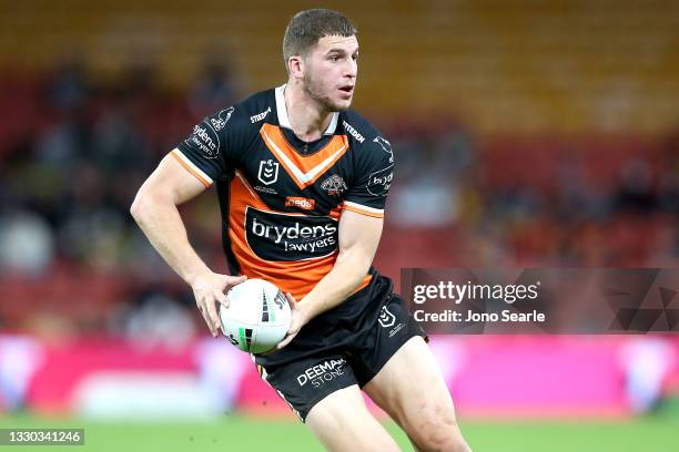 Jacob Liddle of the Tigers passes the ball during the round 19 NRL match between the Manly Sea Eagles and the Wests Tigers at Suncorp Stadium, on...