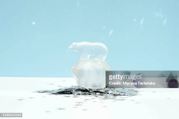 figurine of a polar bear on a blue background. - funny polar bear stock pictures, royalty-free photos & images