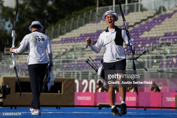 San An and Je Deok Kim of Team South Korea react after winning the gold medal for the Mixed Team competition on day one of the Tokyo 2020 Olympic...