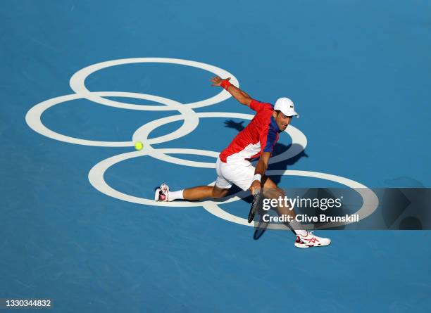 Novak Djokovic of Team Serbia plays a backhand during his Men's Singles First Round match against Hugo Dellien of Team Bolivia on day one of the...