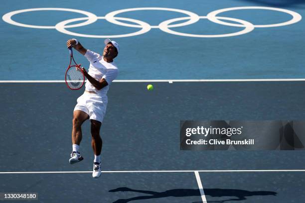 Aslan Karatsev of Team ROC plays a smash during his Men's Singles First Round match against Tommy Paul of Team USA on day one of the Tokyo 2020...