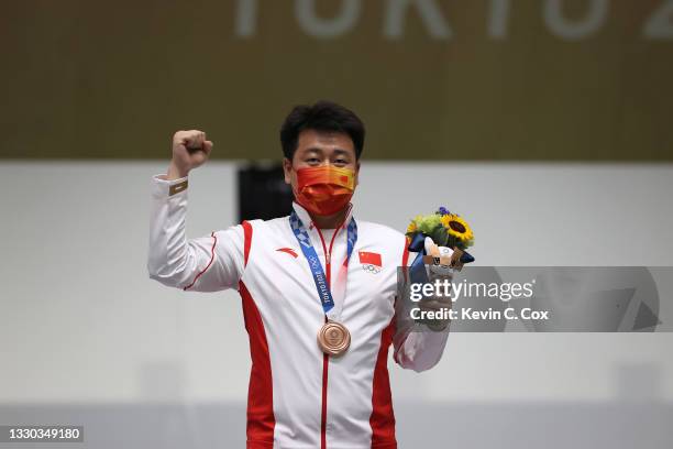 Bronze Medalist Wei Pang of Team China poses on the podium following the 10m Air Pistol Men's event on day one of the Tokyo 2020 Olympic Games at...