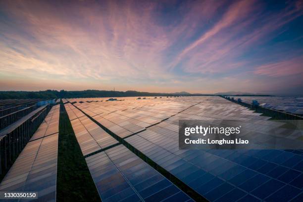 a solar photovoltaic plant in the sunset - solar farm stockfoto's en -beelden