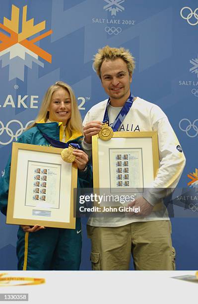 Alisa Camplin and Steven Bradbury, Australia's two gold medalists, pose with their commemorative stamps and gold medals during the Australian Press...