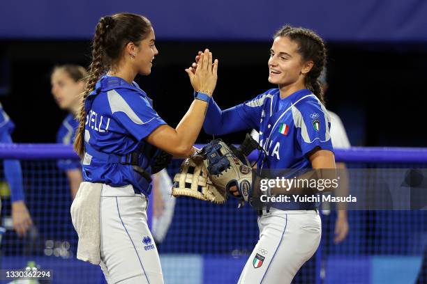 Starting pitcher Alexia Lacatena celebrates with Erika Piancastelli of Team Italy against Team Japan during the Softball Opening Round on day one of...