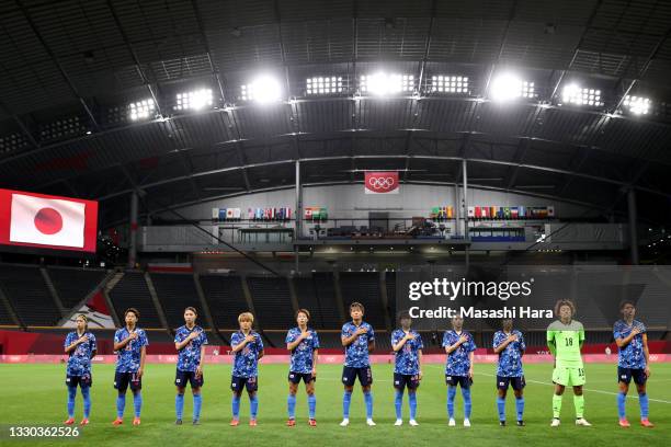 Players of Team Japan stand for the national anthem prior to the Women's First Round Group E match between Japan and Great Britain on day one of the...