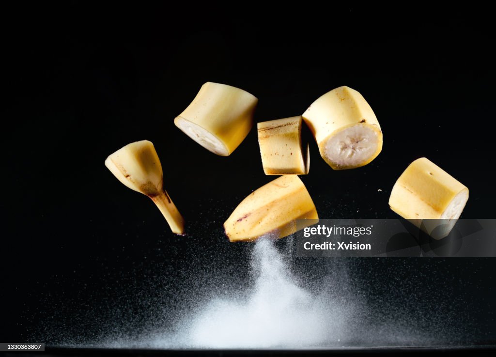 Cut banana flying in mid air captured with high speed sync.