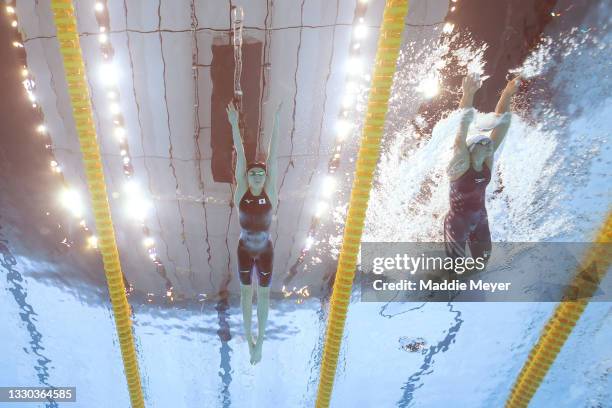 Yui Ohashi of Team Japan and Hali Flickinger of Team United States compete in heat two of the Women's 400m Individual Medley on day one of the Tokyo...