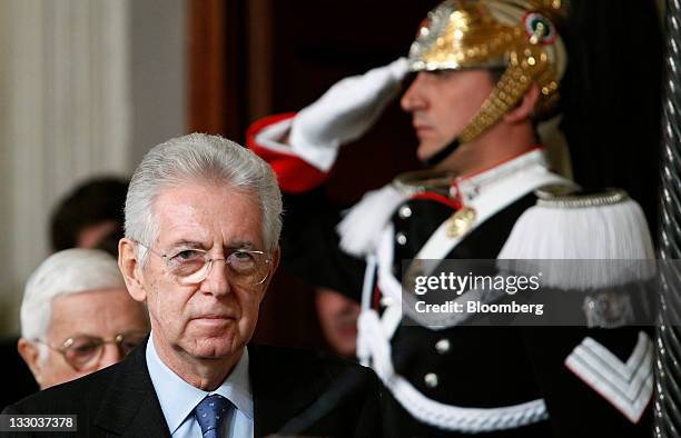 Mario Monti, Italy's prime minister designate, second left, arrives at a news conference to announce the names of the cabinet ministers that will...