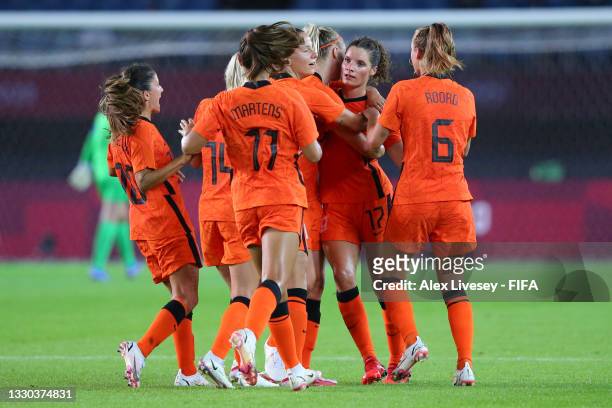 Dominique Janssen of Team Netherlands celebrates with team mates after scoring their side's third goal during the Women's First Round Group F match...