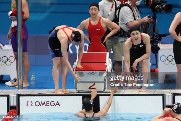 Chihiro Igarashi, Rikako Ikee, Natsumi Sakai and Rika Omoto of Team Japan celebrate after coming fifth in heat two of the Women's 4 x 100m Freestyle...