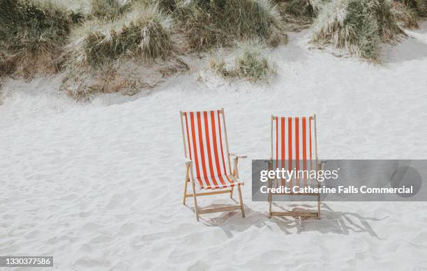 two traditional striped deckchairs on a soft sandy beach - hammock no people stock pictures, royalty-free photos & images