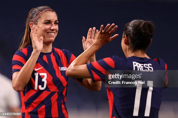 Alex Morgan of Team United States celebrates their side's sixth goal, an own goal by Catherine Bott of Team New Zealand with team mate Christen Press...