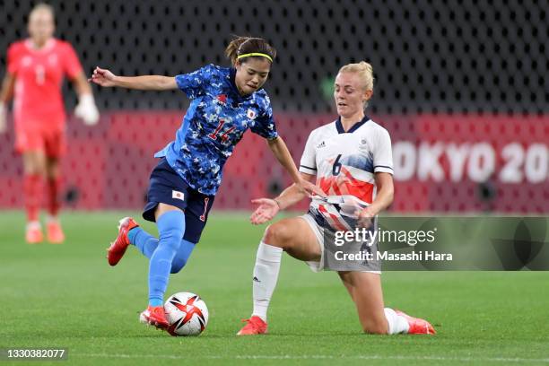 Yui Hasegawa of Team Japan is challenged by Sophie Ingle of Team Great Britain during the Women's First Round Group E match between Japan and Great...