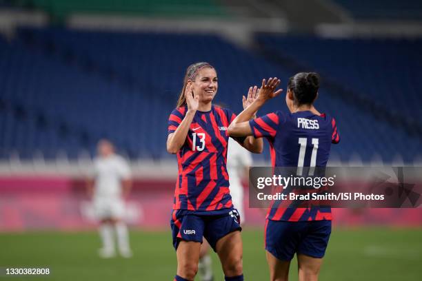 Alex Morgan and Christen Press of the United States celebrate during a game between New Zealand and USWNT at Saitama Stadium on July 24, 2021 in...