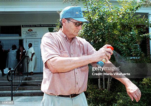 Phil Bethell sprays on mosquito repellent during a stop near the Louisiana exas border on Interstate 20 August 9, 2002 at the Greenwood, Louisiana...