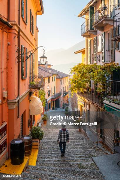 tourist walking on empty alley of traditional village, italy - lombardy fotografías e imágenes de stock
