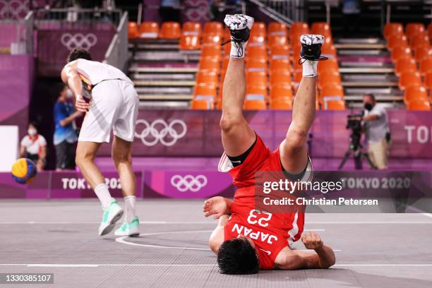 Ryuto Yasuoka of Team Japan falls on the court during the Men's Pool Round match between Belgium and Japan on day one of the Tokyo 2020 Olympic Games...