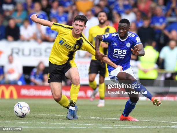 Tom O'Connor of Burton Albion is challenged by Patson Daka of Leicester City during the Pre-Season Friendly match between Burton Albion and Leicester...