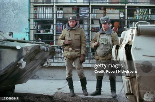 View of two Soviet army soldiers on a sidewalk in an unspecified shopping district, Kabul, Afghanistan, April 25, 1988. The country had been under...