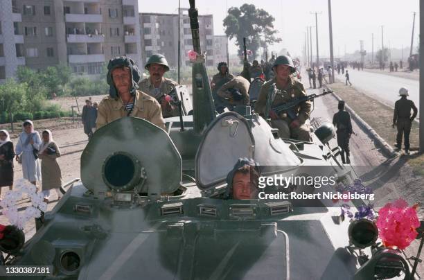 View of Soviet army soldiers as they ride on a line of armored vehicles during the final Soviet troop withdrawal, Kabul, Afghanistan, May 15, 1988....