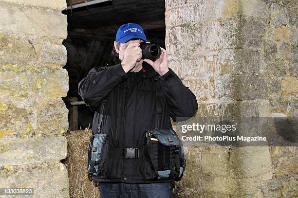 Photographer with a Canon EOS 450D camera and Kata AB-302 Harness at Tadwick Farm, Bath, January 13, 2011.