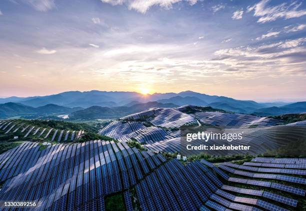 drone point of view at the solar power station on the top of the mountain at sunset - solar equipment stock pictures, royalty-free photos & images