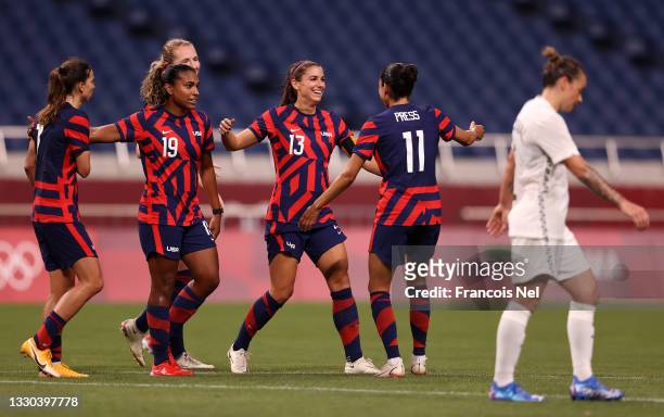 Alex Morgan of Team United States celebrates with Catarina Macario and Christen Press after scoring their side's fifth goal during the Women's First...