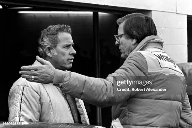 Driver David Pearson, left, talks with Bud Moore, owner of the Wrangler Jeans car driven by Dale Earnhardt Sr, in the Daytona International Speedway...