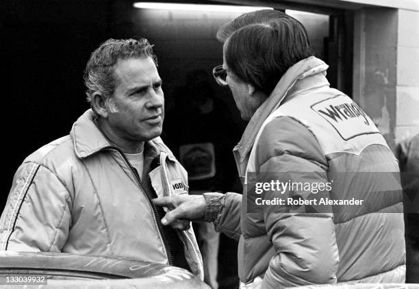 Driver David Pearson, left, talks with Bud Moore, owner of the Wrangler Jeans car driven by Dale Earnhardt Sr, in the Daytona International Speedway...