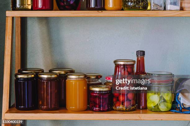 kitchen pantry. jams, preserved food and other stable foods on shelf - speisekammer stock-fotos und bilder