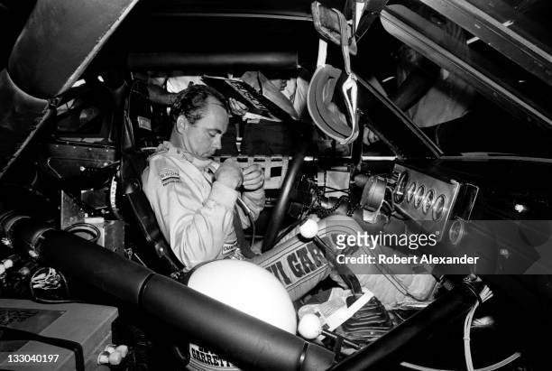 Driver Geoff Bodine sits in his car while he prepares for the start of the 1985 Daytona 500 at the Daytona International Speedway on February 17,...