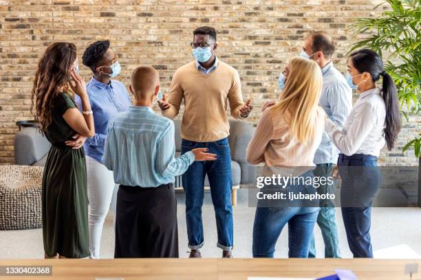 business people attending a seminar with social distancing and face mask - group of people wearing masks stock pictures, royalty-free photos & images