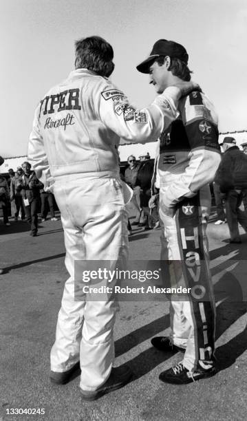 Driver Bobby Allison, left, talks with his son, fellow race driver Davey Allison, in the Daytona International Speedway garage prior to the 1988...