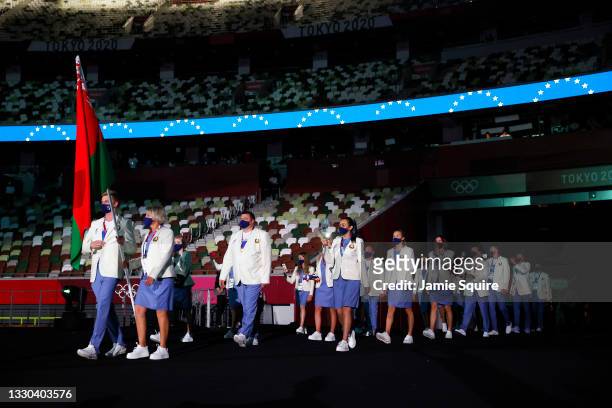Flag bearers Mikita Tsmyh and Hanna Marusava of Team Belarus walk out during the Opening Ceremony of the Tokyo 2020 Olympic Games at Olympic Stadium...