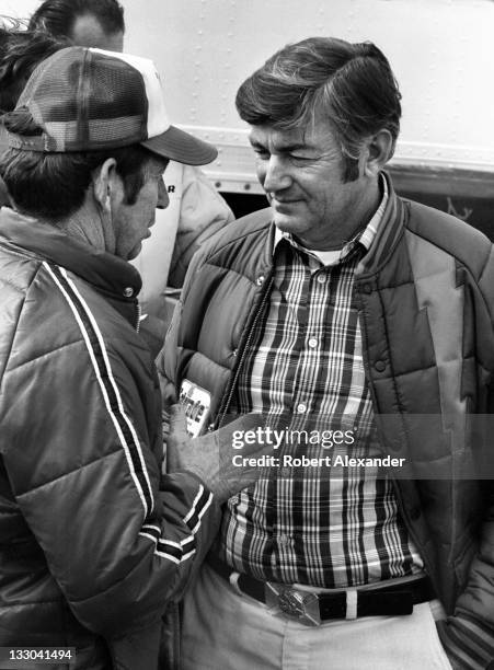 Driver Bobby Allison, right, talks with his brother, fellow race driver Donnie Allison, in the Daytona International Speedway garage prior to the...