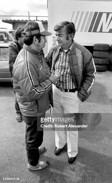 Driver Bobby Allison, right, talks with his brother, fellow race driver Donnie Allison, in the Daytona International Speedway garage prior to the...