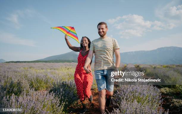 love couple running a kite - kite stock pictures, royalty-free photos & images