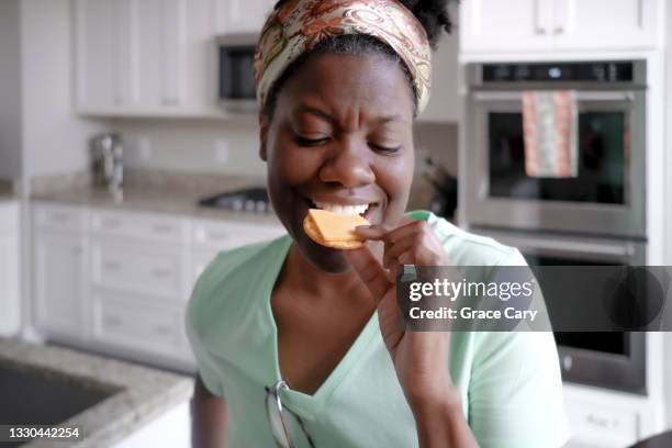 woman snacks on crackers and cheese - eating cheese stockfoto's en -beelden