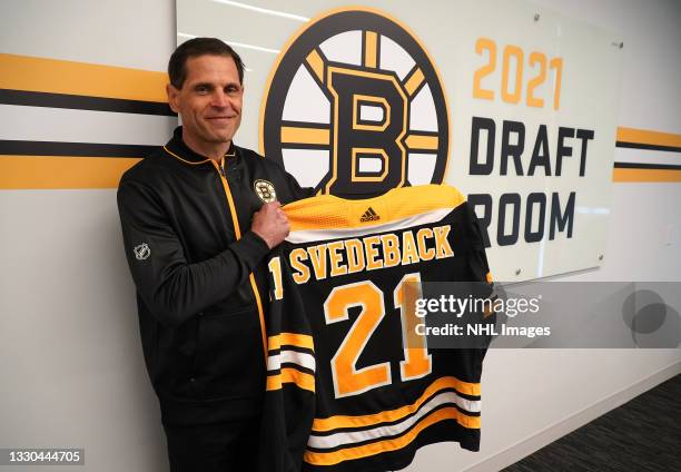 General Manager Don Sweeney of the Boston Bruins holds the jersey of the Bruins' fourth round pick Philip Svedeback, 117th overall, in the 2021 NHL...