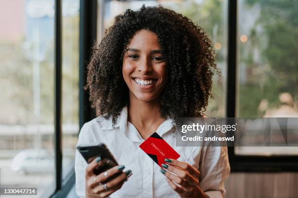 woman holding credit card - hand paying smartphone stock pictures, royalty-free photos & images