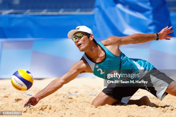 Katsuhiro Shiratori of Team Japan returns against Team Poland during the Men's Preliminary - Pool F on day two of the Tokyo 2020 Olympic Games at...