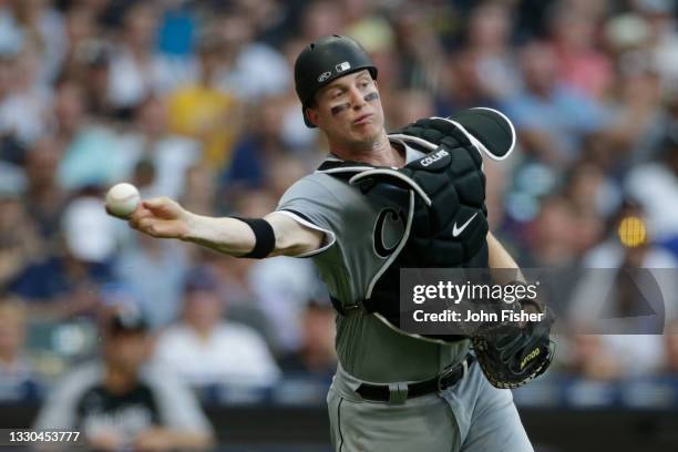 Zack Collins of the Chicago White Sox throws wide of first base on the play for an error in the fourth inning against the Milwaukee Brewers at...