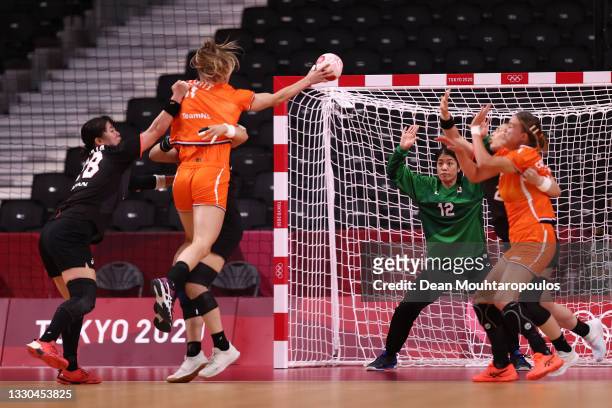 Nycke Groot of Team Netherlands shoots on goal at goalkeeper Minami Itano of Team Japan during the Women's Preliminary Round Group A match between...