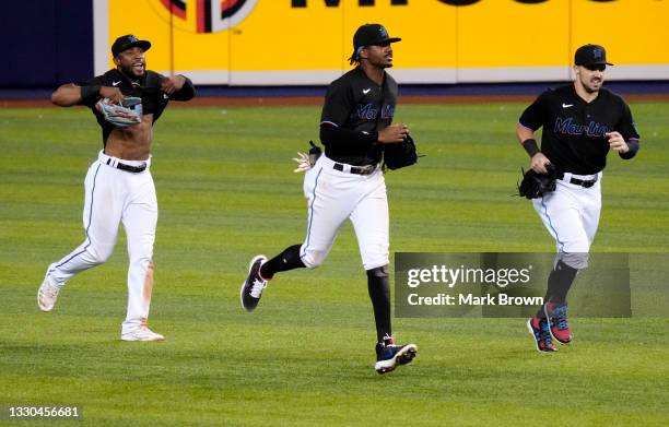 Starling Marte, Lewis Brinson, Adam Duvall of the Miami Marlins celebrate after defeating the San Diego Padres by score of 3-2 at loanDepot park on...