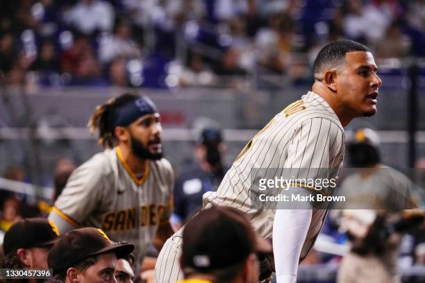 Manny Machado and Fernando Tatis Jr. #23 of the San Diego Padres argue with umpire Bill Miller in the sixth inning against the Miami Marlins at...