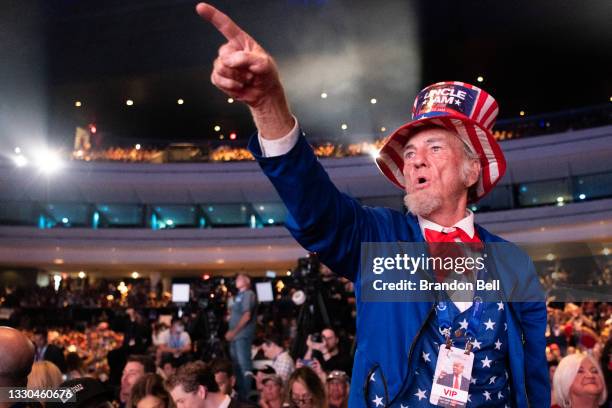 Man points towards the stage ahead of former U.S. President Donald Trump's appearance at the Rally To Protect Our Elections conference on July 24,...