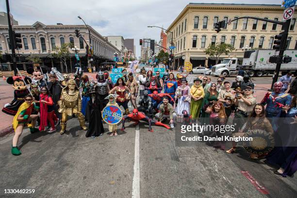 Group of cosplayers pose for a photo at the end of a cosplayer parade down 5th Avenue at the San Diego Causeplayer Community Shrine at San Diego...