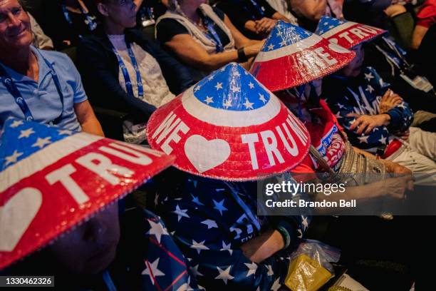 People wearing Donald Trump apparel listen during the Rally To Protect Our Elections conference on July 24, 2021 in Phoenix, Arizona. The...