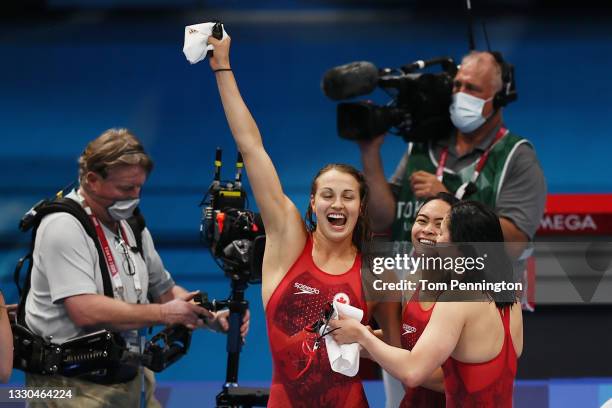 Rebecca Smith, Kayla Sanchez and Margaret MacNeil of Team Canada react after winning the silver medal in the Women's 4 x 100m Freestyle Relay Final...